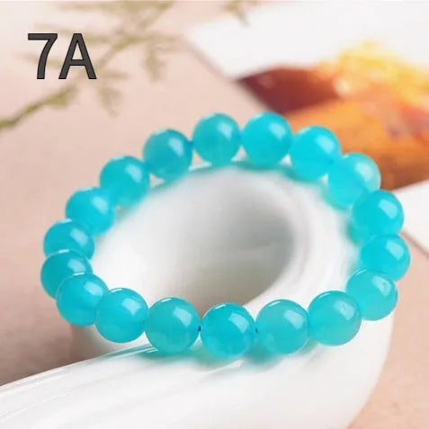 Natural amazonite scattered beads in ice colour grades for jewellery making, showing polished surfaces and size variations