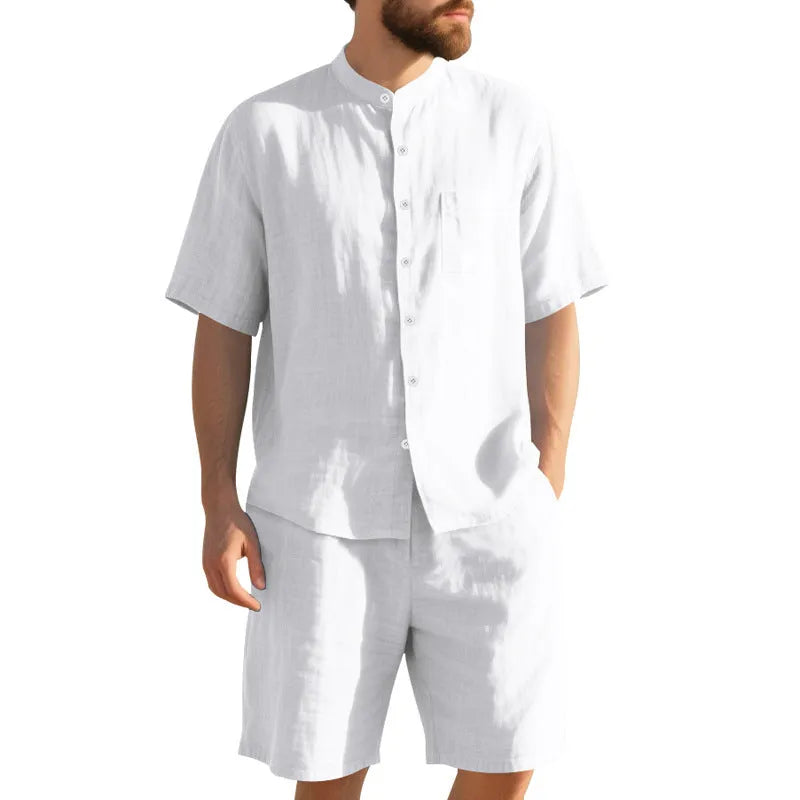 Man wearing a light blue short sleeve linen shirt jacket and matching shorts, a two-piece summer suit.