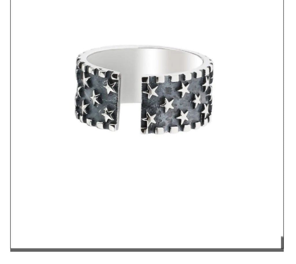Adjustable silver ring with a multi five-pointed star geometric pattern.
