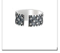 Adjustable silver ring with a multi five-pointed star geometric pattern.