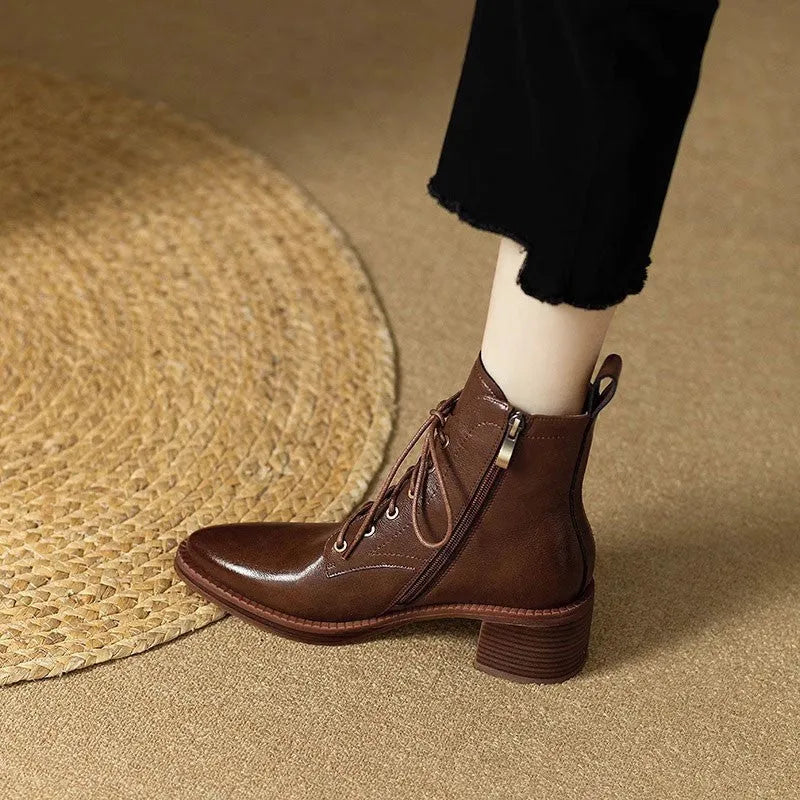 Women's black and brown pointed-toe ankle boots with a 5.5cm heel on a plain background