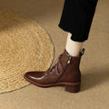 Women's black and brown pointed-toe ankle boots with a 5.5cm heel on a plain background