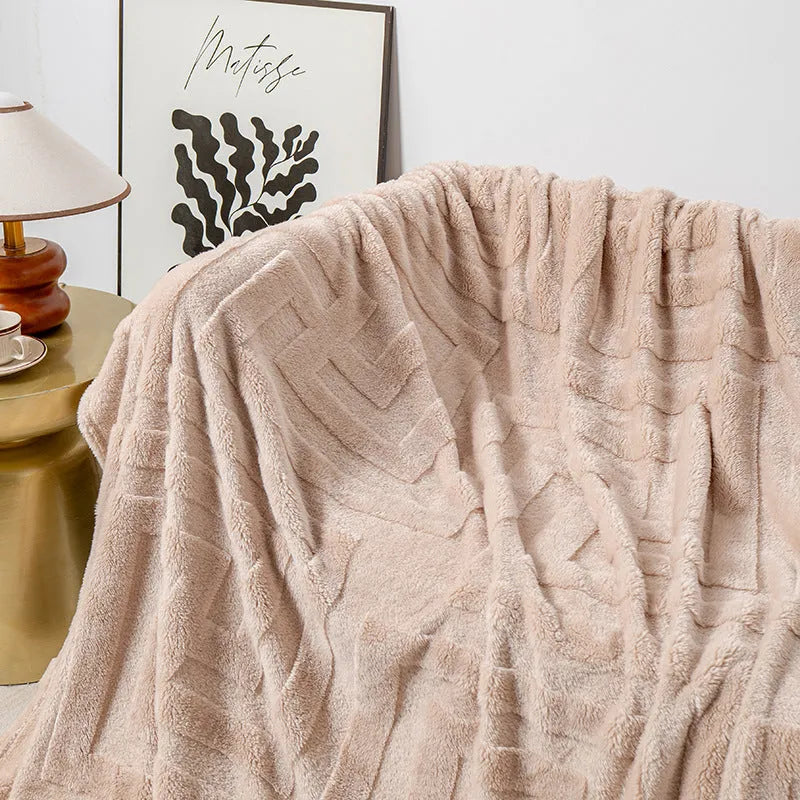 Thick square coral fleece flannel blanket with solid colour and floral pattern, folded to show texture.
