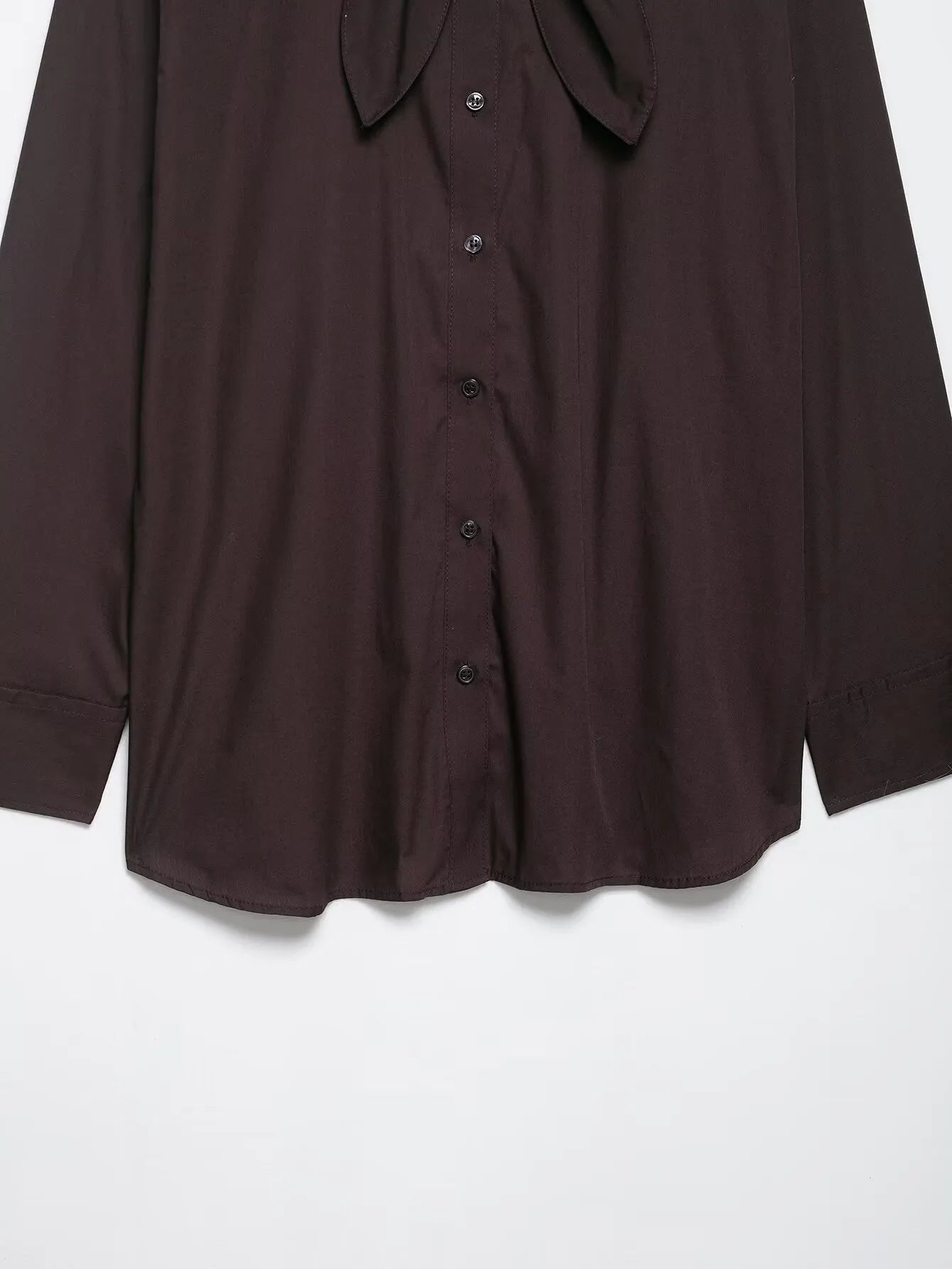 Brown women's loose-fit poplin shirt with long sleeves and a built-in bow tie detail.