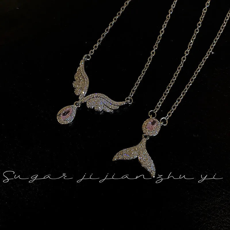 Women's sterling silver necklace with geometric angel wing or fishtail pendant on an O-ring chain.
