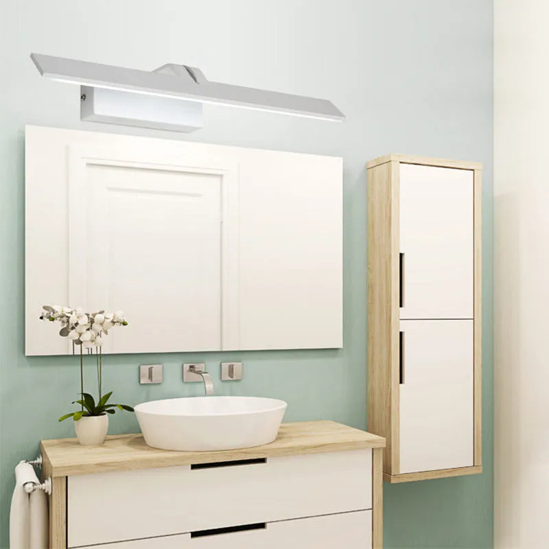 White wall-mounted LED mirror headlight with integrated mirror surface, shown in a bathroom setting.