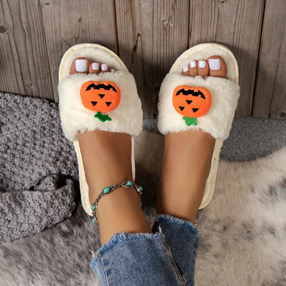 White and yellow Halloween pumpkin plush open toe slippers with synthetic fur and PVC sole.