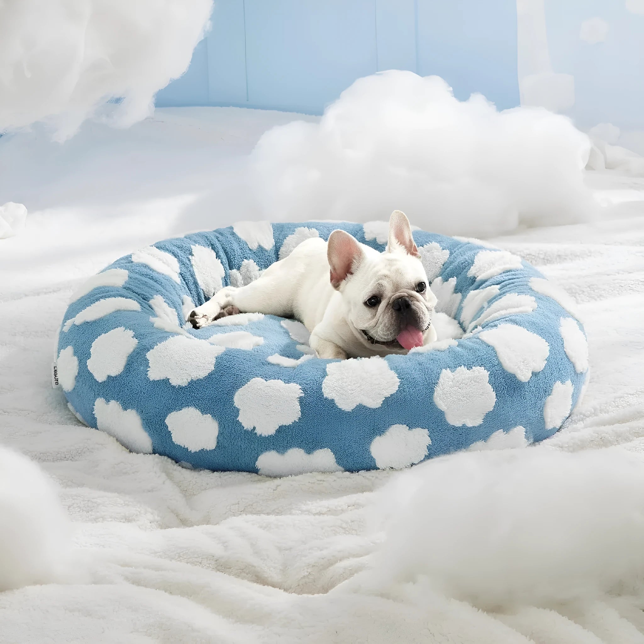 Round plaid dog bed with plastic base on a wooden floor