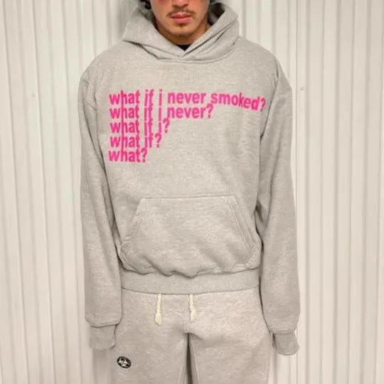 Black hooded sweater with white letter print on the front, shown on a model.