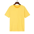 A man's loose-fitting black cotton t-shirt with short sleeves on a hanger.