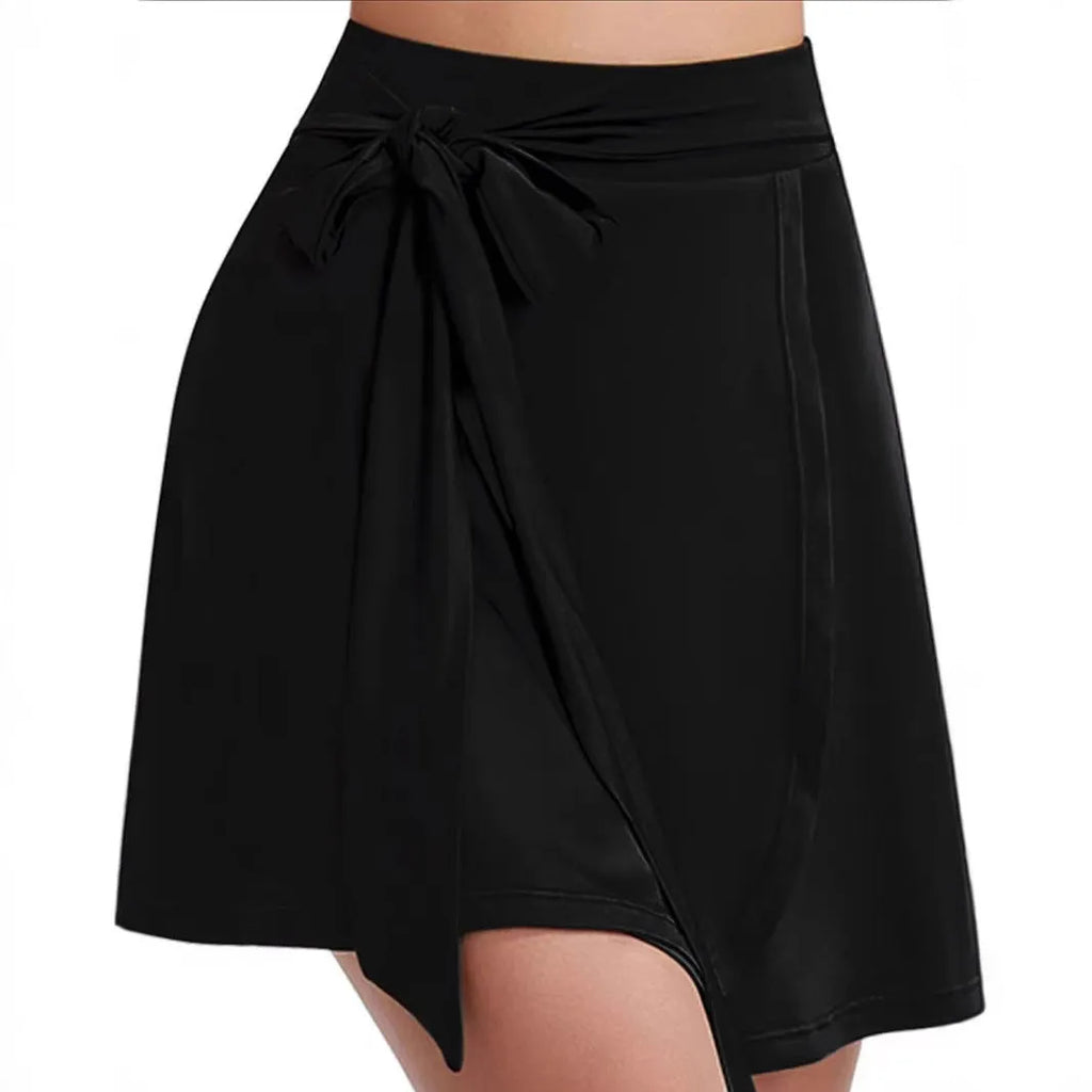 Black thigh-length sports skirt with built-in shorts and shoulder strap detailing
