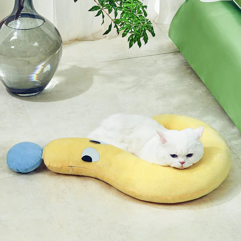 Blue pet sleeping pillow measuring 62cm by 39cm on a dog bed