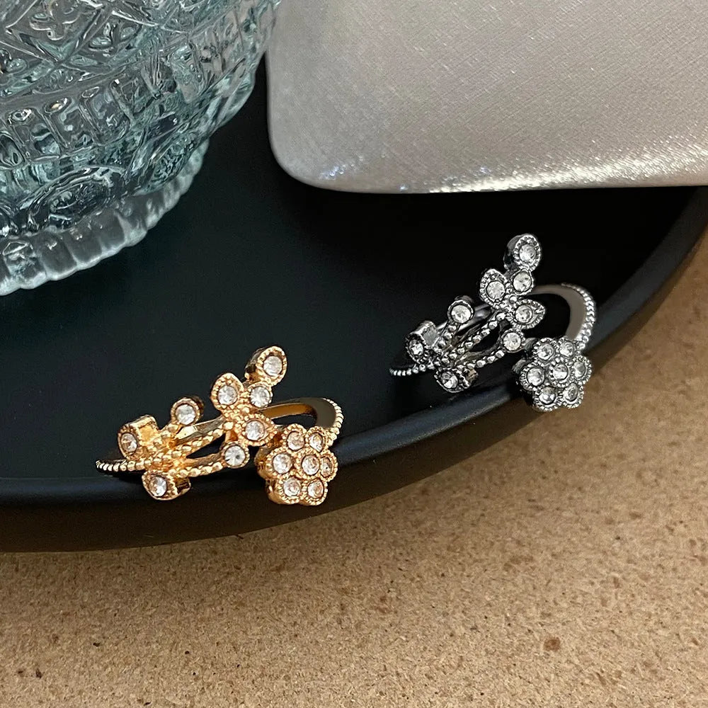 Women's copper open ring with a diamond-faceted flower and leaf design in gold and white colour options.