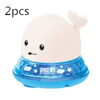 White and blue whale bath toy spraying water with LED lights illuminated