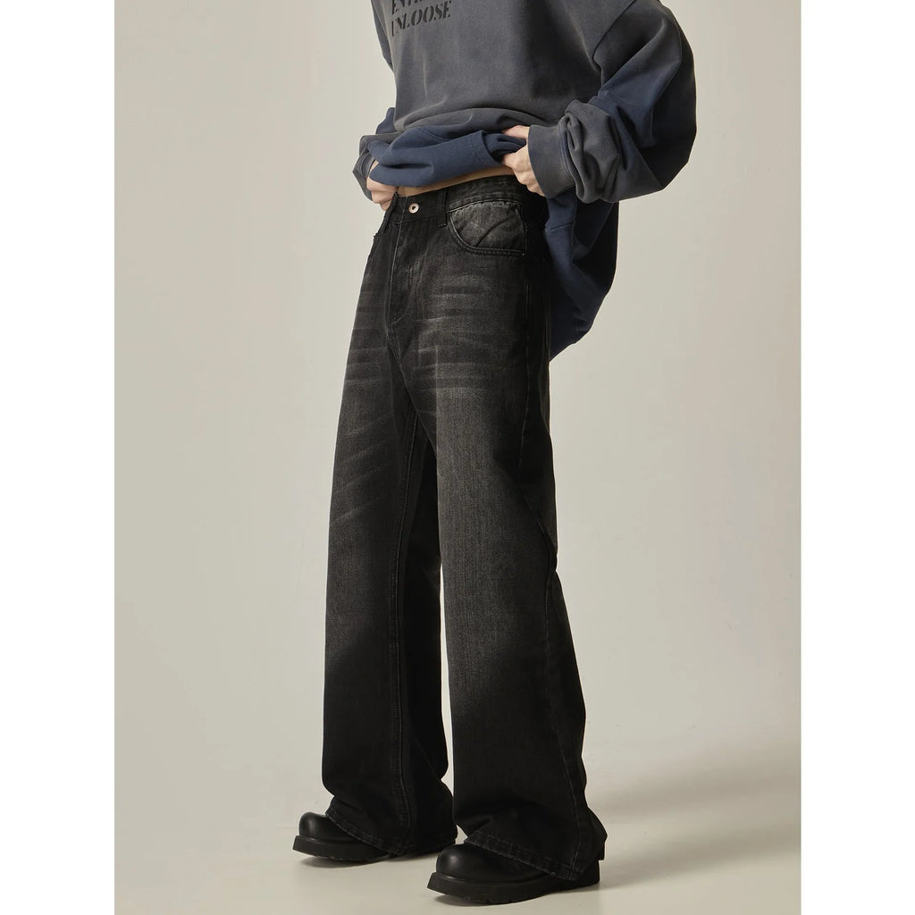 Black loose-fit straight leg denim jeans on a mannequin, showing the zip fly and retro style.