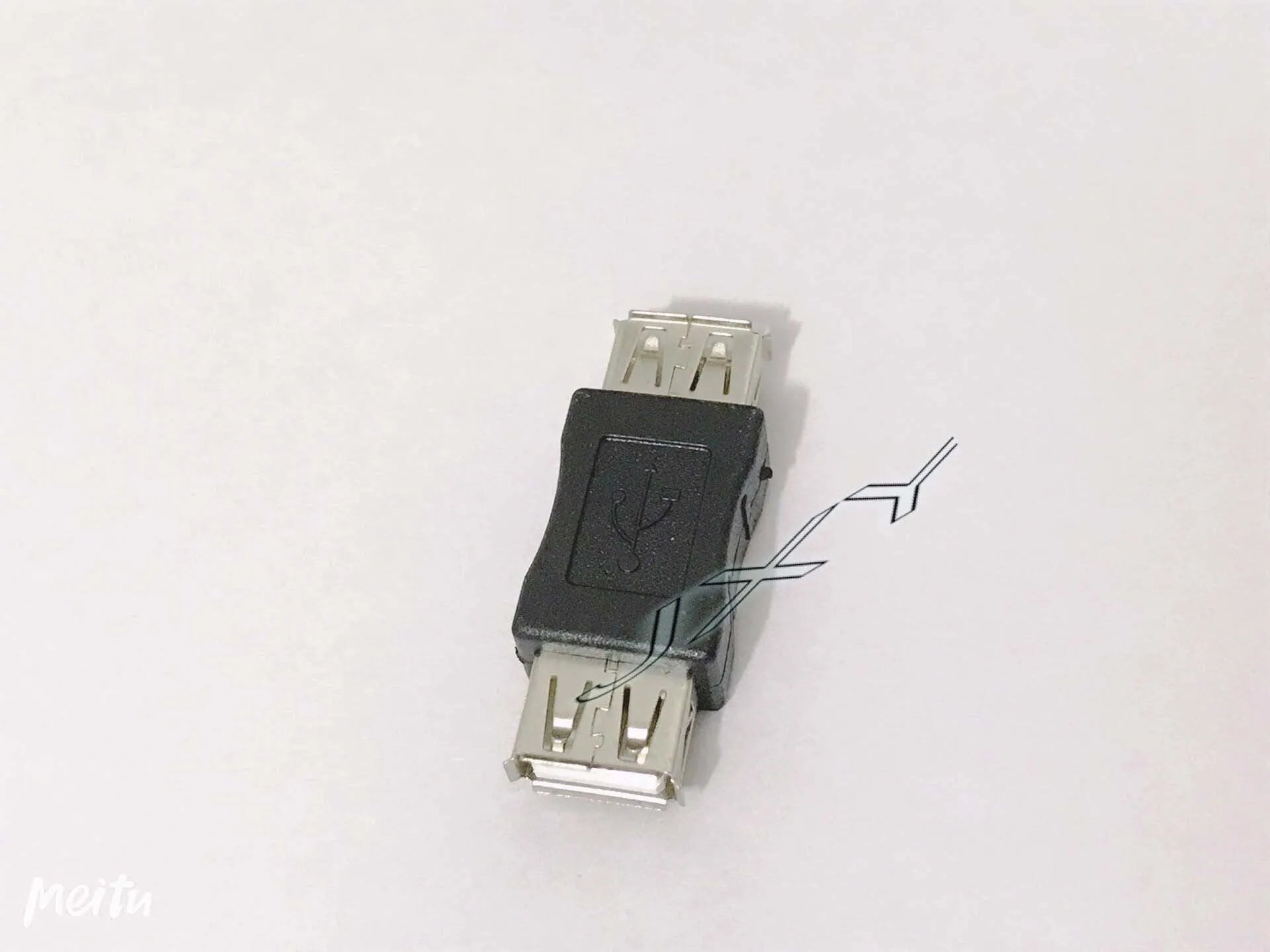 Black male A to mini mike conversion plug adapter on white background