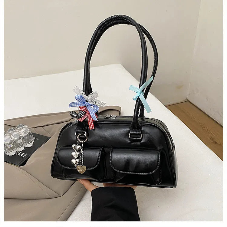 Retro pillow-shaped PU leather women's handbag with double shoulder strap in black colour with ribbon pendant