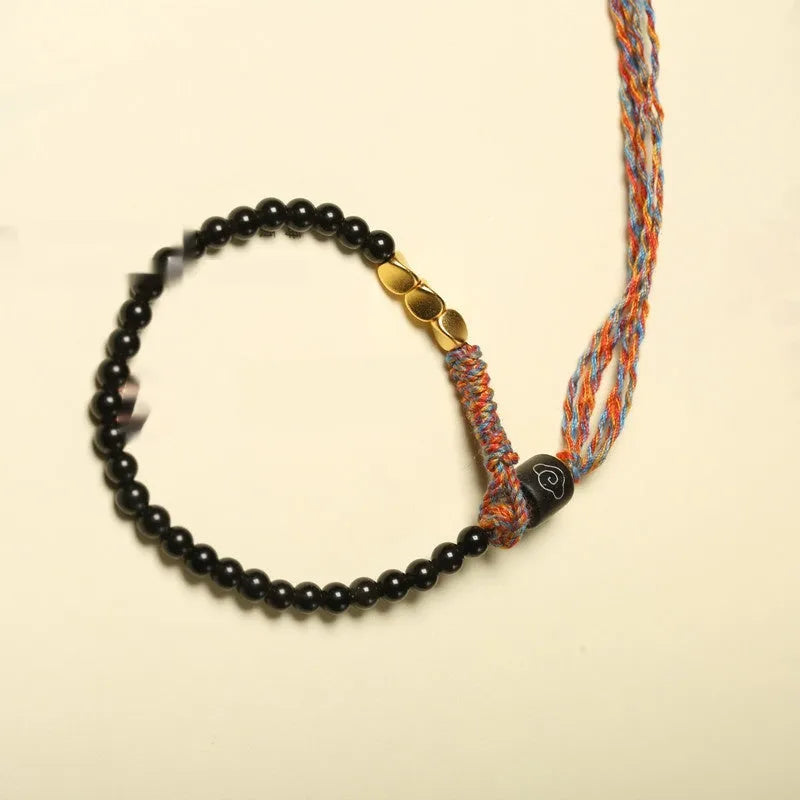 Hand-woven obsidian carrying strap bracelet with textured finish on wrist