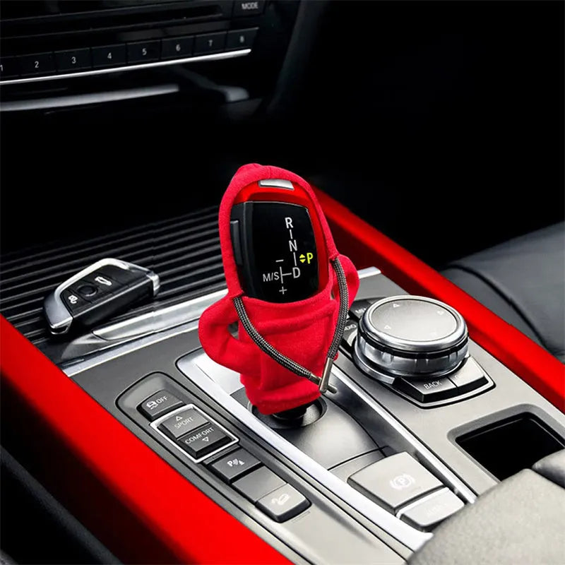 Universal cotton gear knob cover hoodie in blue with adjustable drawstring on a car shift knob