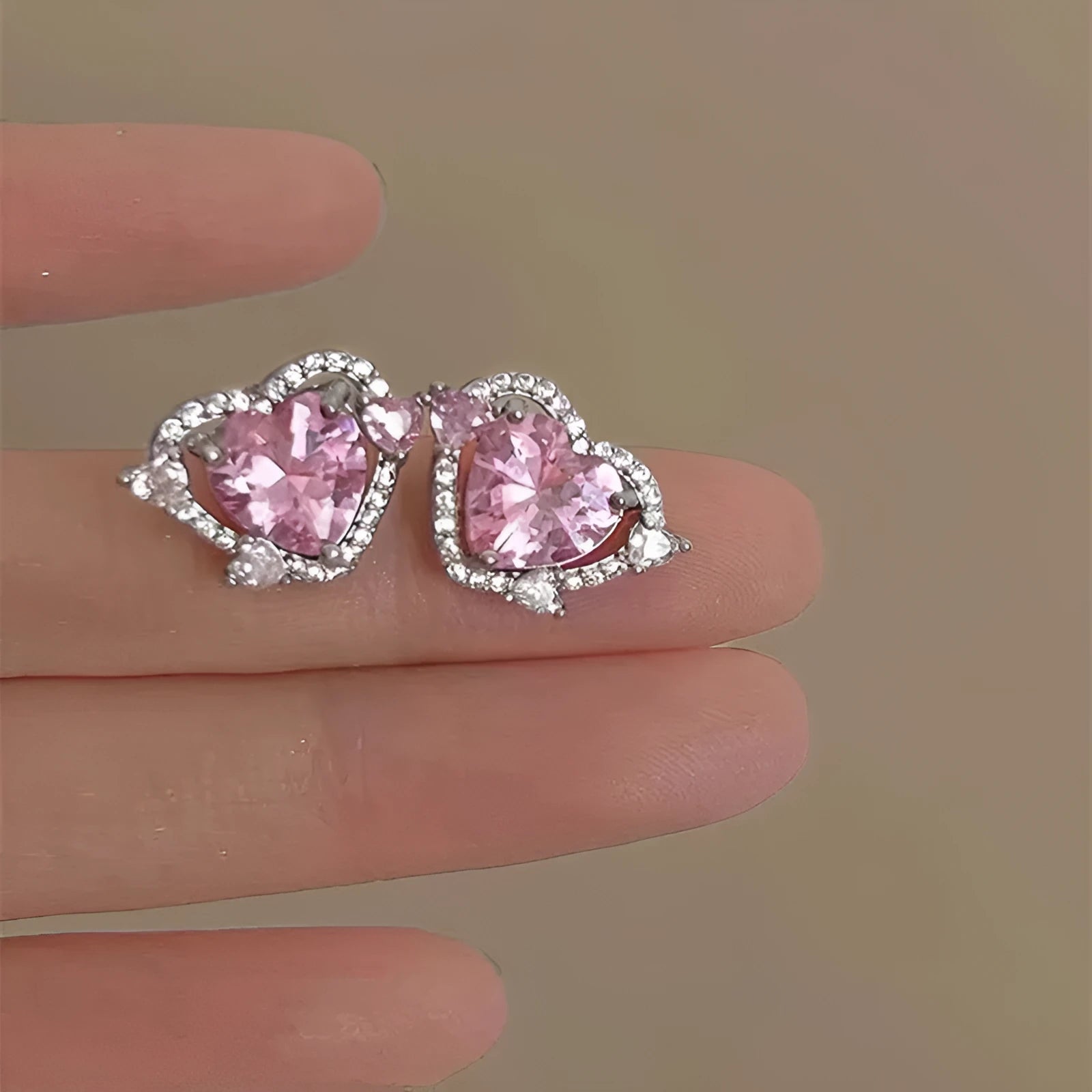A pair of heart-shaped stud earrings with a white gold colour finish.