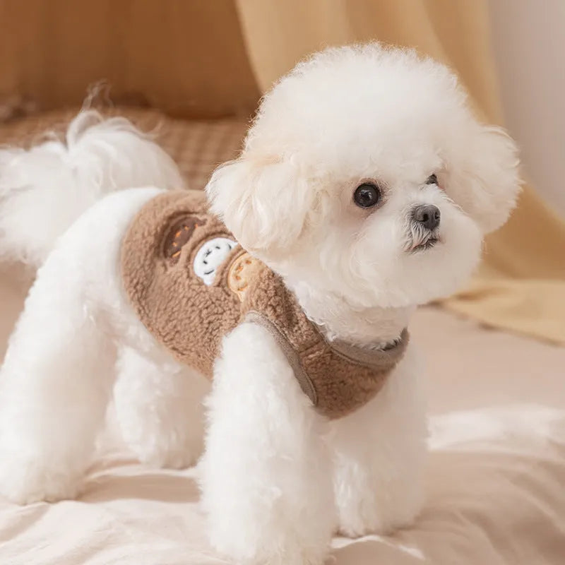 Brown fleece dog coat with bear embroidery and side-button closure on a small dog
