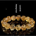 Natural yellow citrine gemstone bracelet with geometric beads on a white background.