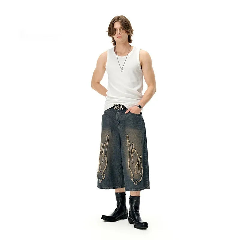 Men's black denim shorts with flame embroidery patch on straight leg cropped design