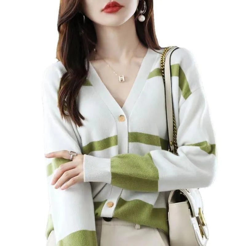 Women's black and white striped knitted cardigan with 3D pattern, V-neck, and button-up front.