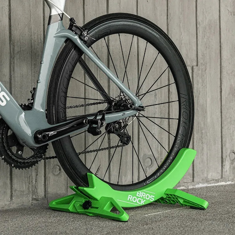 Black ABS plastic bicycle parking rack holder mounted on wall with mountain bike