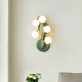 Modern minimalist French pastoral wall lamp with a green tricolour light and white PC shade mounted on a bedroom wall.