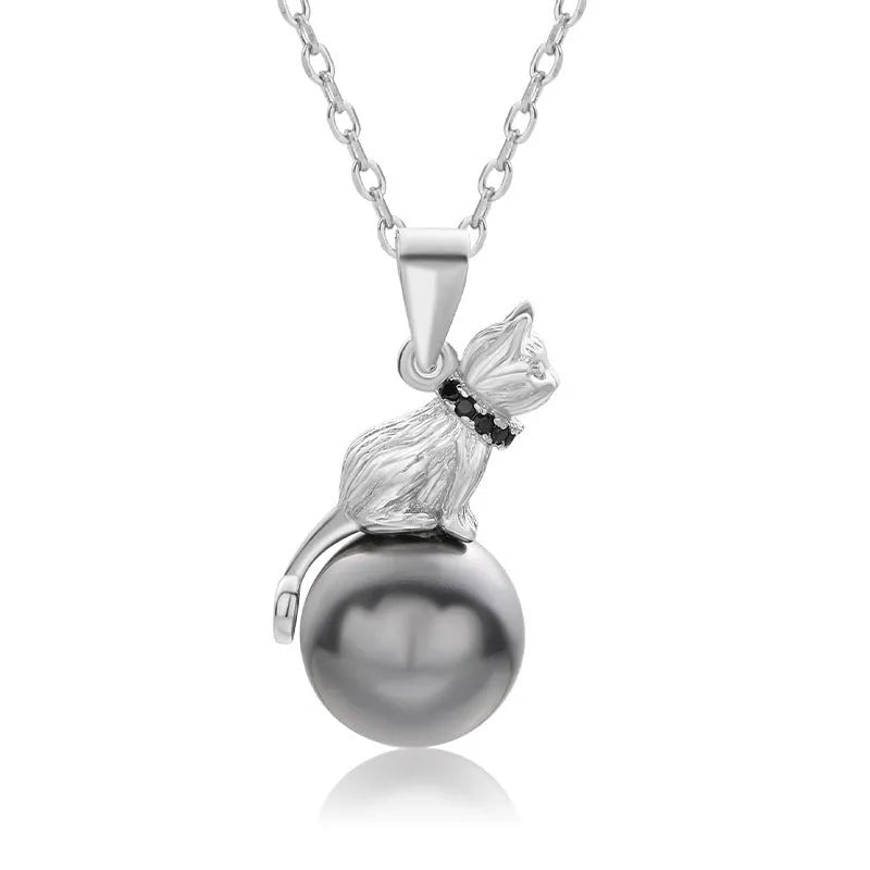 Close-up of a sterling silver cat pendant necklace on a chain with an electroplated finish.