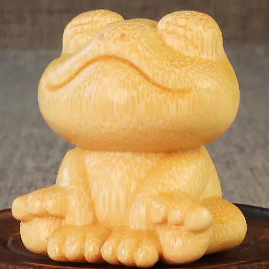 Solid bamboo smiling frog carving ornament measuring 5cm height with cartoon style design