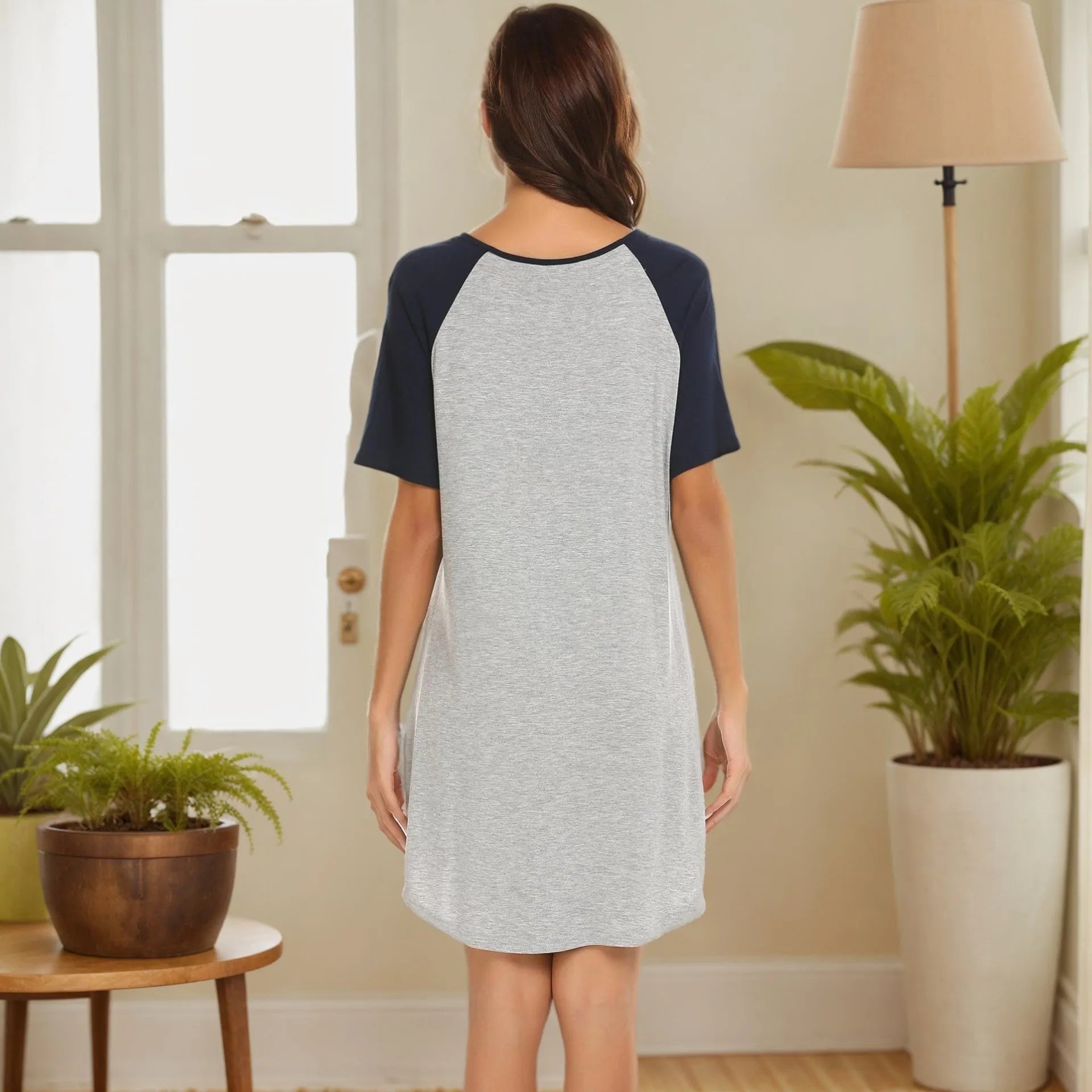 Women's patchwork nightdress with navy blue contrast sleeves on a light grey body.