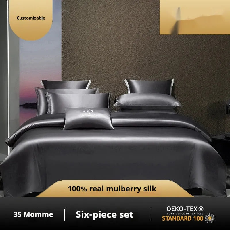 Solid colour silk quilt cover and pillowcases from a four-piece bedding set in a champagne gold hue on a bed.