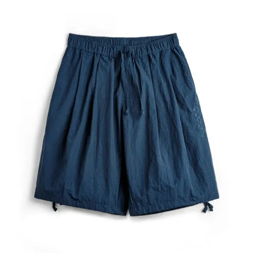 Prussian Blue men's loose beach shorts with embroidered detailing on thin nylon fabric