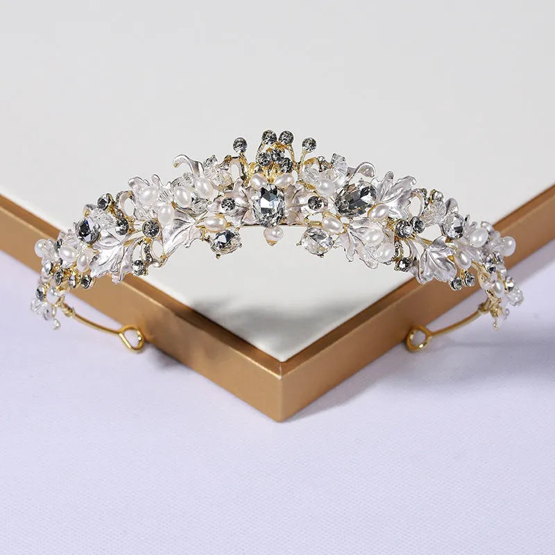 A gold-coloured alloy crown headdress for women with glass pearl decorations on a model's hair.