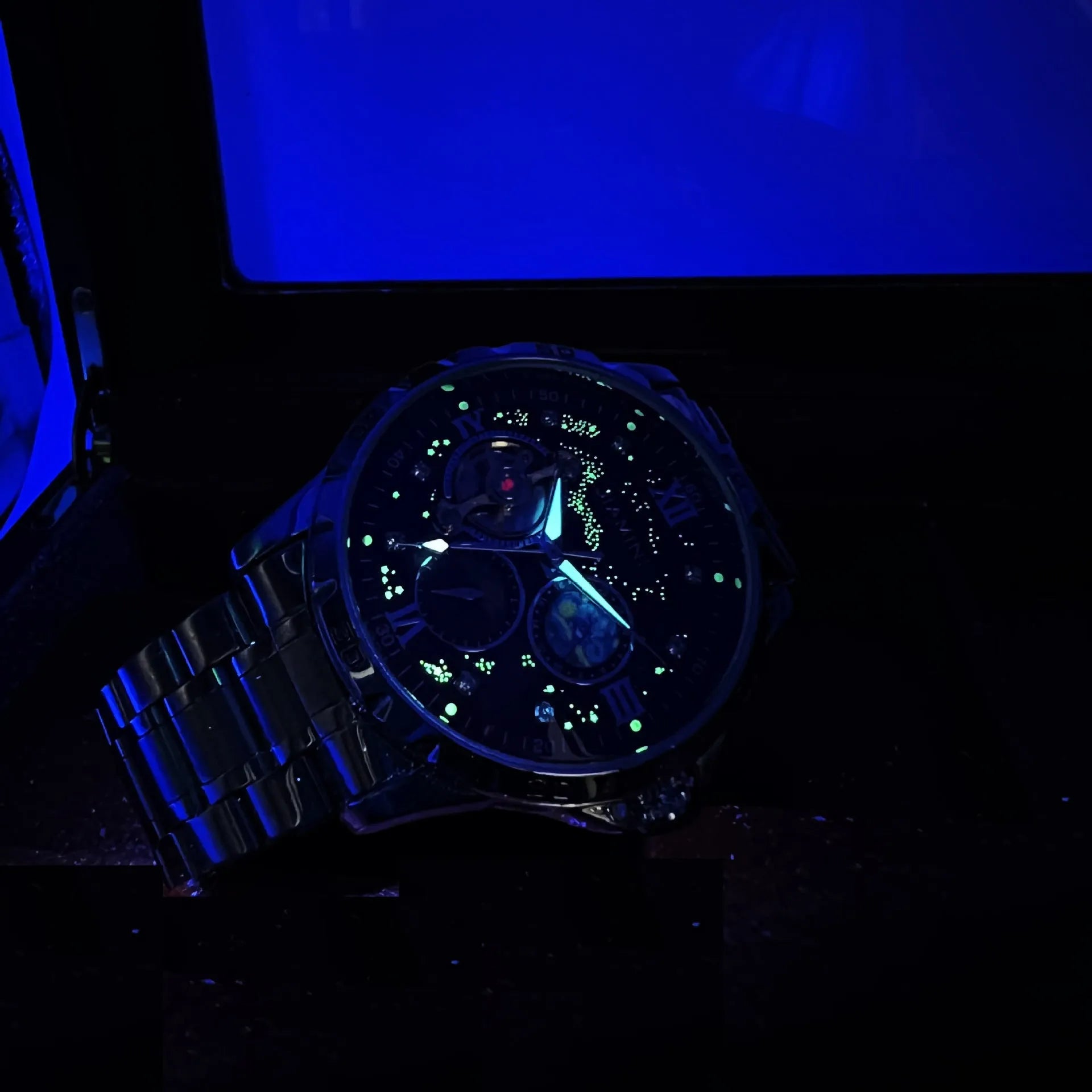 Automatic mechanical men's watch with large black dial and rose gold case, showing 12mm thickness.
