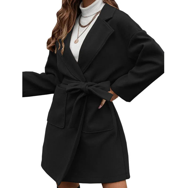 Minimalist long sleeve casual coat with lapel buttons and a split belt in a loose Japanese Korean style.