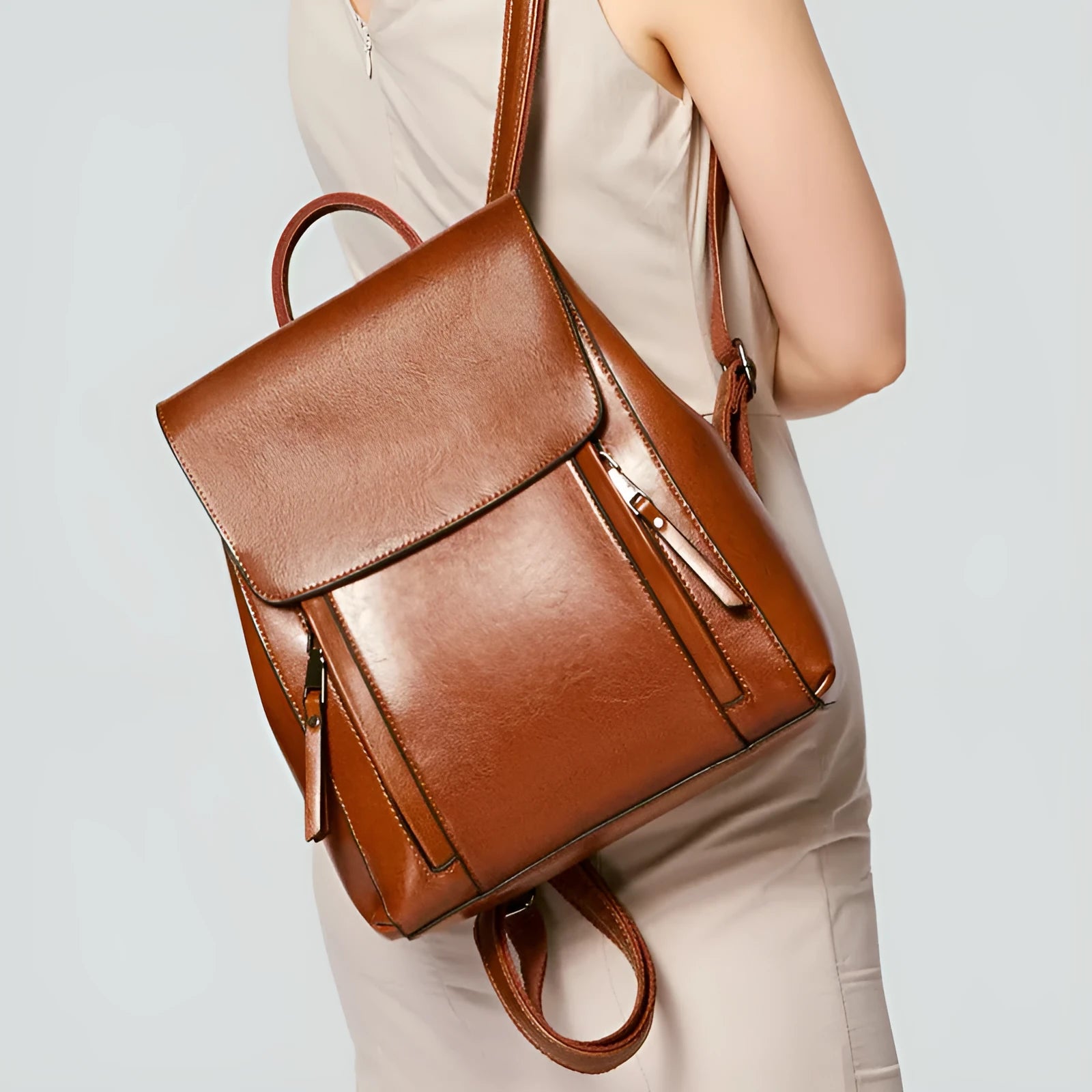 Large black genuine leather women's backpack with shoulder straps and internal organiser pockets.