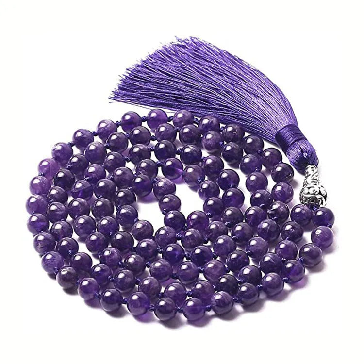 Long multicoloured agate tassel necklace with geometric beads and a flowing pendant.