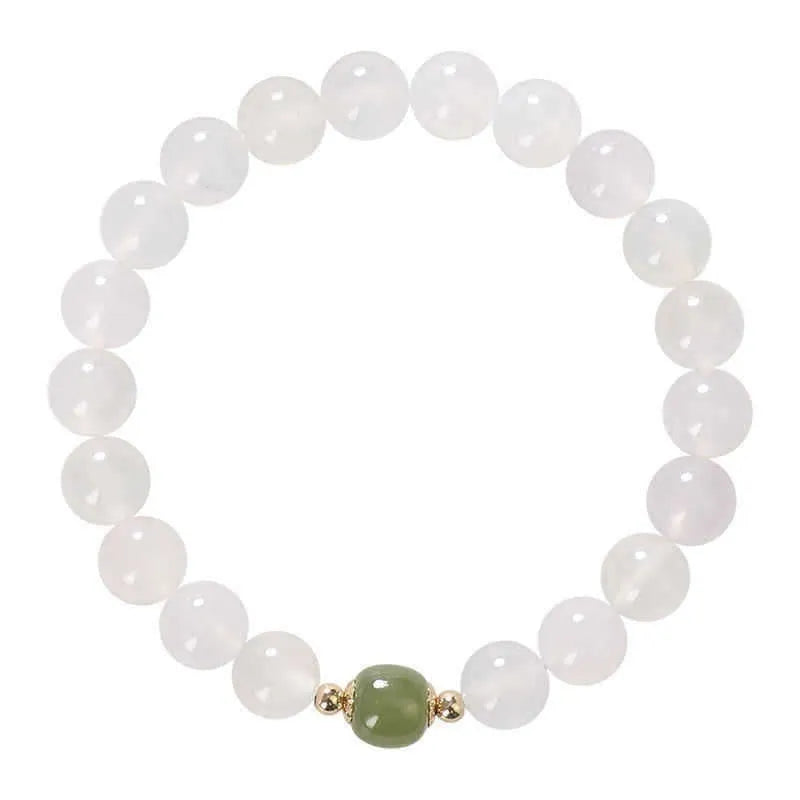 Handmade white agate and crystal bracelet with red cinnabar inlay and text charm.
