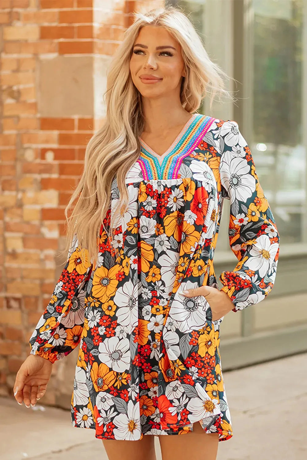 Orange floral print mini dress with V neck, long sleeves and vertical striped lace detailing