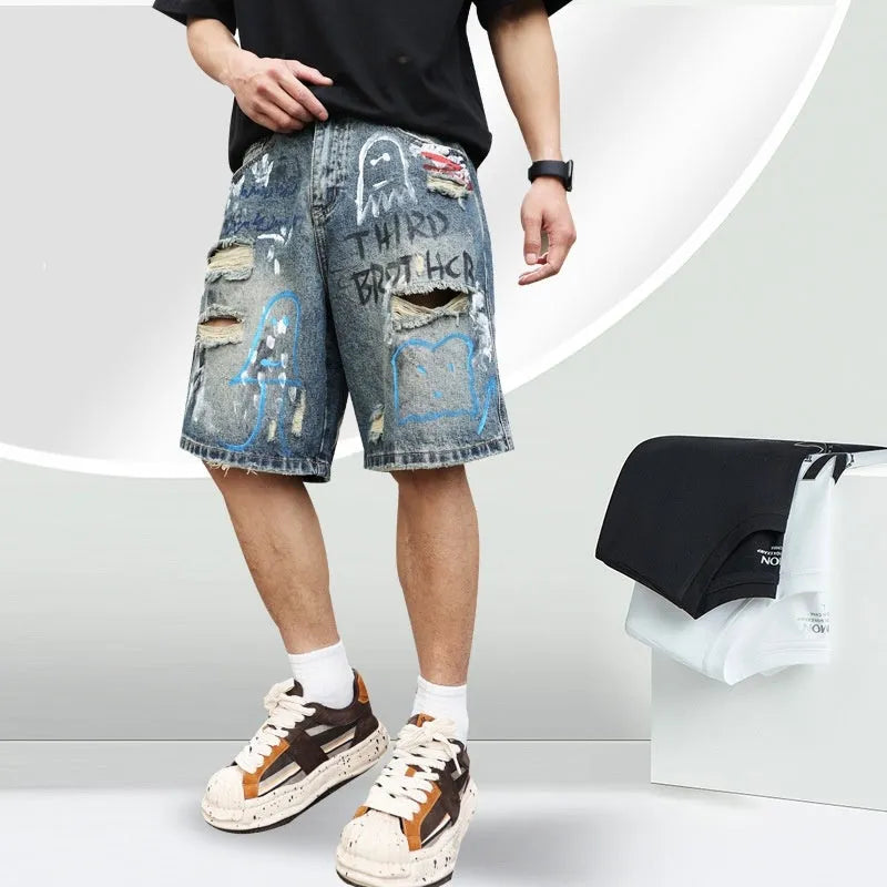 Blue ripped men's denim shorts with graffiti design, showing straight leg and zipper fly.