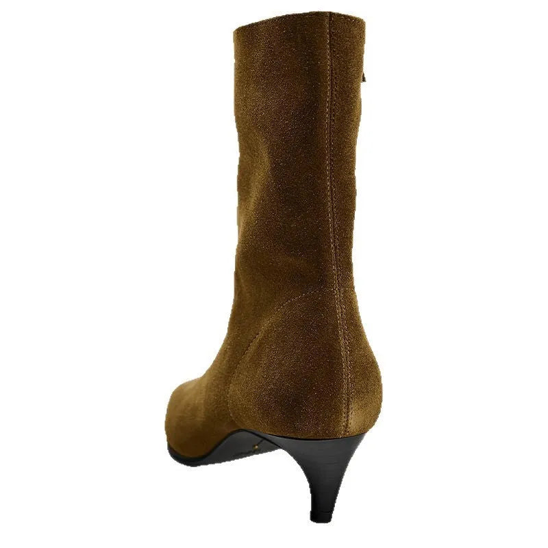 Brown square toe ankle boots with a side zipper and pointed stiletto heel on a wooden floor.