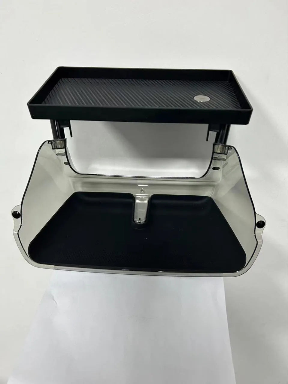 Black ABS storage box for Tesla Model 3 and Y, positioned under the centre touchscreen.