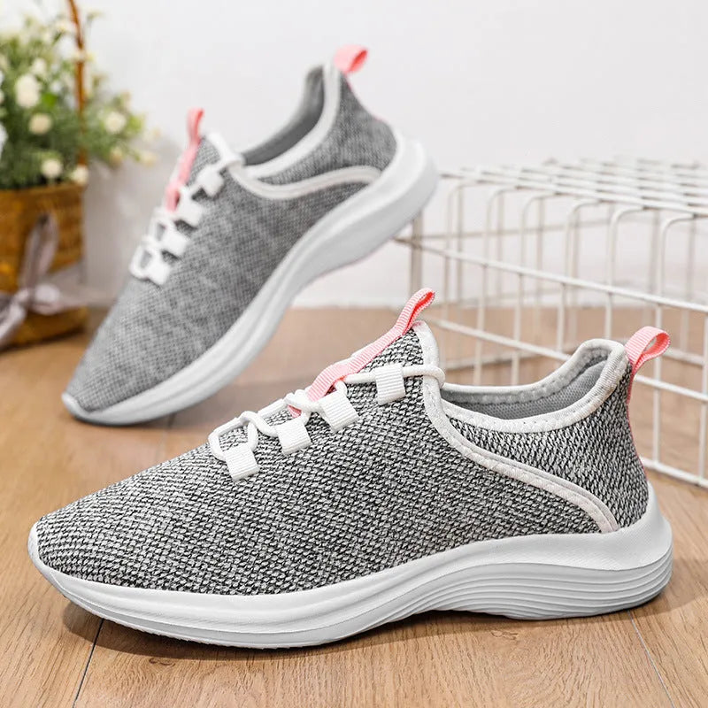 Women's low-top casual sneakers with Flyknit mesh upper in black, pink, or grey with round toe and lace-up front