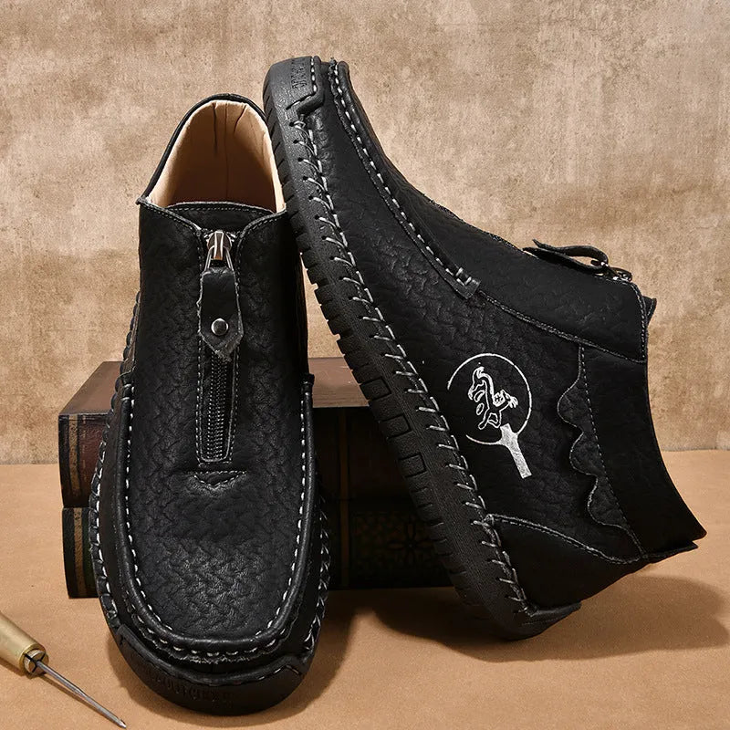 Men's black slip-on loafers with round toe and flat rubber sole on a white background.