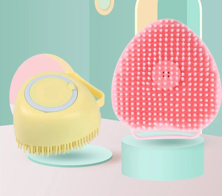 Silicone dog bath and massage brush in blue, pink, and yellow colours on a white background