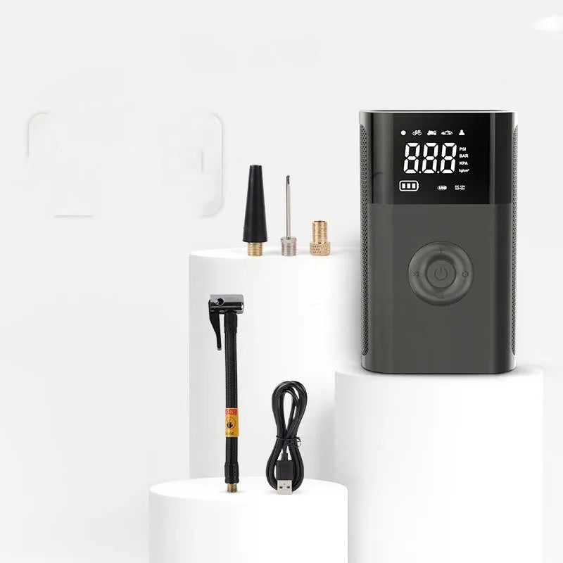Wireless handheld digital air pump with display screen showing tyre pressure, surrounded by nozzle attachments for car, bicycle and sports inflation