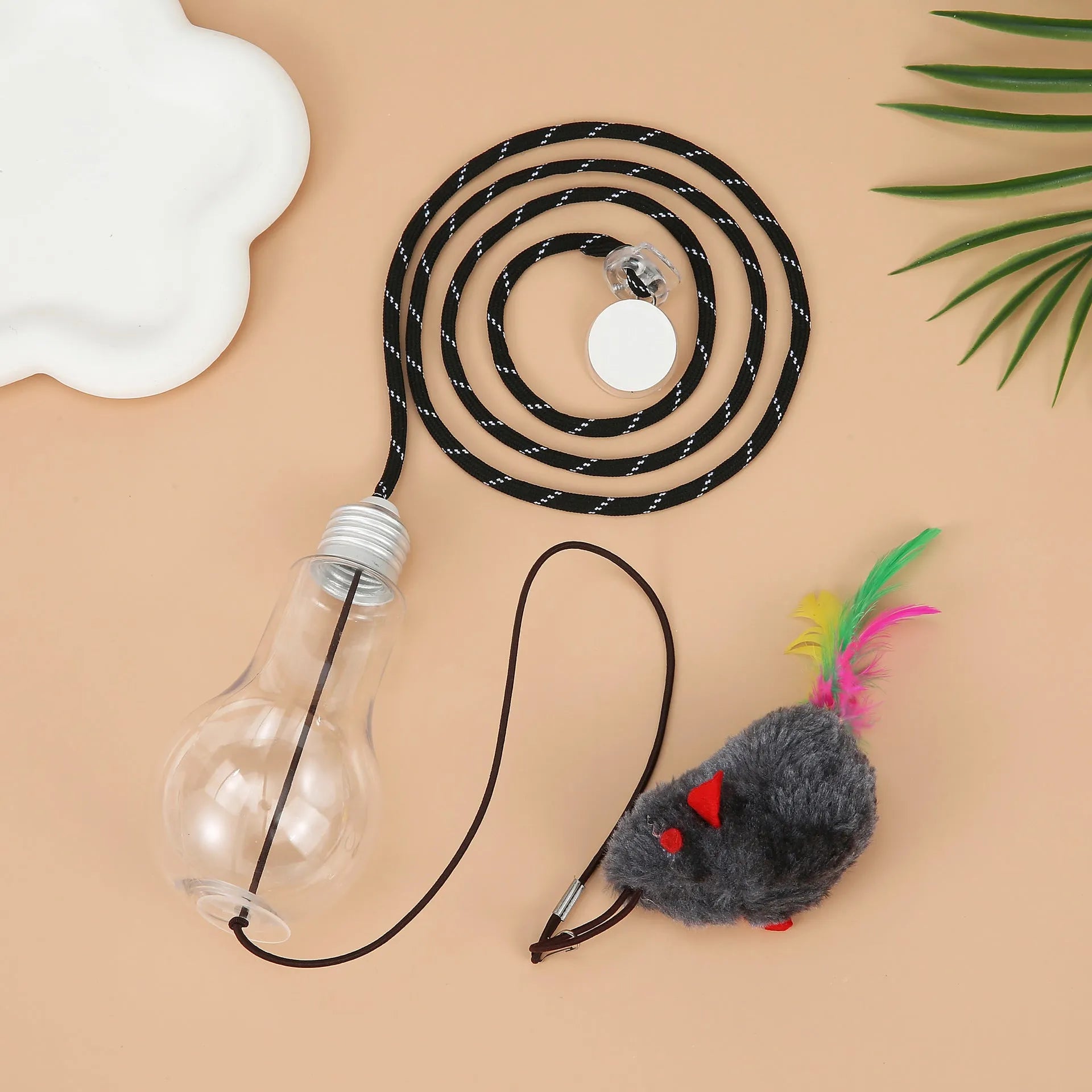 Grey interactive cat toy hanging from door frame with retractable elastic rope, treat dispenser bulb, and dangling mouse attachment